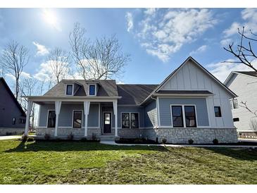 Charming single-Gathering home showcasing stone accents, a covered porch, and a well-manicured lawn on a sunny day at 1433 Chatham Hills Blvd, Westfield, IN 46074