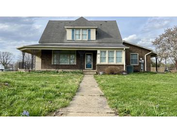 Charming two-story brick home featuring a cozy front porch and well-maintained lawn at 232 N Church St, Morgantown, IN 46160