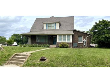 Charming brick home with a well-maintained lawn and classic architectural details at 232 N Church St, Morgantown, IN 46160