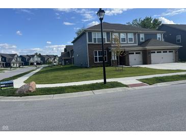 Two-story home with brick and siding, attached two-car garage, and well-manicured lawn in a suburban neighborhood at 3609 Merchmont Rd, Bargersville, IN 46106