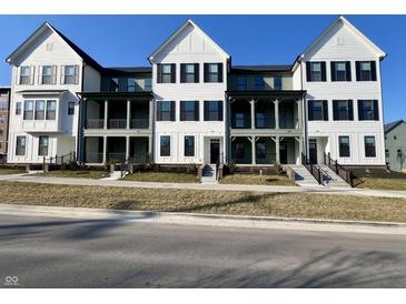 Modern townhomes showcase two-story designs with covered porches, and eye-catching black and white color schemes at 460 W Smoky Row, Carmel, IN 46032