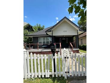 Charming one-story home featuring a quaint front porch and lovely white picket fence at 4143 Graceland Ave, Indianapolis, IN 46208