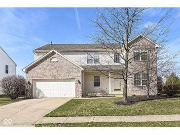 Charming two-story home featuring brick accents, a two-car garage, and a well-maintained lawn at 12912 Broncos Dr, Fishers, IN 46037