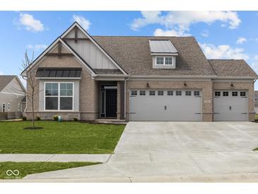 Charming single-story home with a well-manicured lawn, brick facade, and two-car garage at 5034 Bergamot Dr, Brownsburg, IN 46112