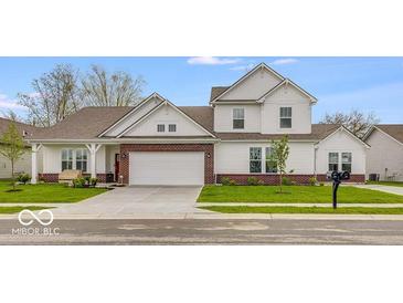 Charming two-story home featuring a brick facade, manicured lawn, and attached two-car garage at 251 Hunters Ridge Dr, Danville, IN 46122