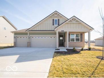 Charming single-Gathering home boasting a two-car garage, neutral siding, and a well-manicured lawn at 245 Lar Lan Dr, Danville, IN 46122