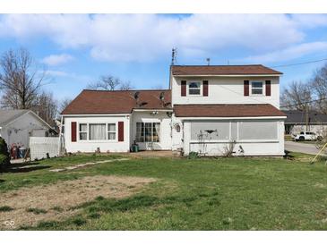 Charming two-story home featuring a covered porch and a well-maintained lawn at 180 N Highland St, Morgantown, IN 46160