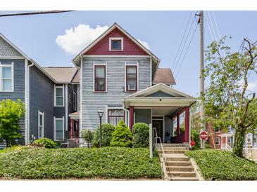 Charming two-story home with mature landscaping and a welcoming front porch and well-maintained exterior at 2036 N Talbott St, Indianapolis, IN 46202