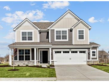Two-story home featuring a two-car garage and a well-manicured lawn under a bright, cloudy sky at 4180 Bozeman Way, Bargersville, IN 46106