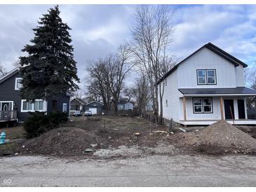 Two story new construction home with white siding, black roof and front porch at 2018 Rembrandt St, Indianapolis, IN 46202