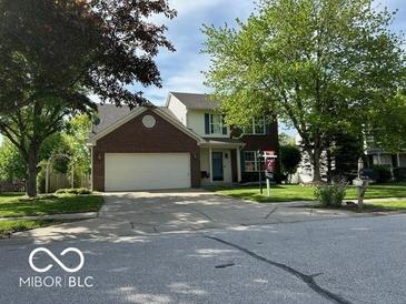Charming two-story home with a brick facade, a well-maintained lawn, and mature trees at 534 Austrian Way, Avon, IN 46123
