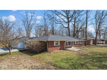 Charming brick ranch home with mature trees and a well-maintained lawn at 827 S Brentwood Ave, Indianapolis, IN 46239