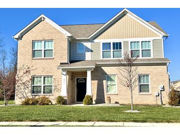 Charming two-story home featuring a well-maintained lawn and a classic brick facade at 5778 W Commonview Dr, McCordsville, IN 46055