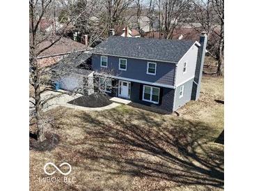 Two story home features a well-maintained yard and a classic, welcoming facade at 839 Fernwood Ct, Indianapolis, IN 46234
