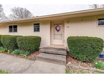 Inviting front entrance with wreath, steps, and manicured shrubbery at 104 Mohawk Ln, West Lafayette, IN 47906