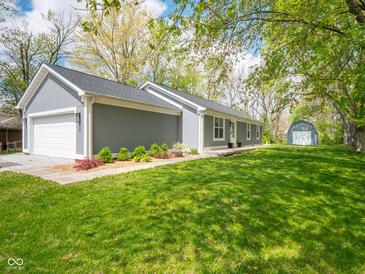 Charming home with attached garage, landscaped front and lush lawn at 104 W County Road 500 S, Clayton, IN 46118