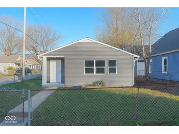Charming single-story home featuring gray siding, crisp white trim, and a well-maintained lawn at 1601 Draper St, Indianapolis, IN 46203