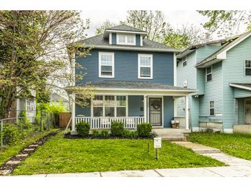 Charming two-story home with blue siding, a cozy front porch, and well-maintained landscaping at 3047 N New Jersey St, Indianapolis, IN 46205