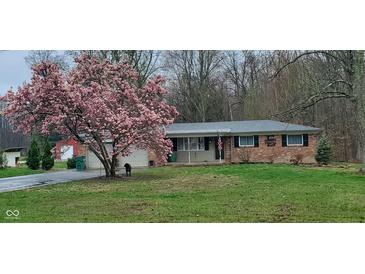 Charming brick home with a beautifully blooming magnolia tree in the front yard at 8190 Beech Grove Rd, Martinsville, IN 46151
