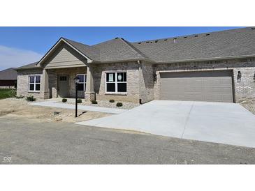 Charming single-story brick home with a two-car garage and concrete driveway at 2327 Saddle Dr, Shelbyville, IN 46176