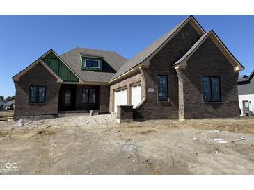 New construction, brick home featuring an attached two car garage and modern window designs at 5469 Harness Dr, Greenwood, IN 46143