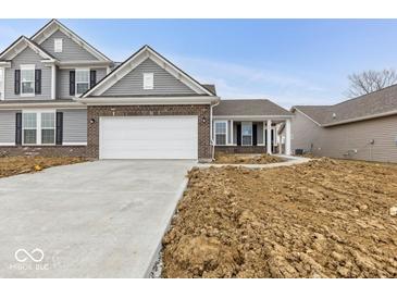 Charming two-story home with gray siding, brick accents, and an attached two-car garage at 235 Hunters Ridge Dr, Danville, IN 46122