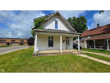 Charming two-story home featuring a cozy front porch, quaint design, and a well-maintained lawn at 310 S Pleasant St, Edinburgh, IN 46124