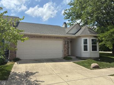 Charming single-Gathering home with a two-car garage, brick accents, and a well-manicured lawn at 8520 Bison Woods Ct, Indianapolis, IN 46227