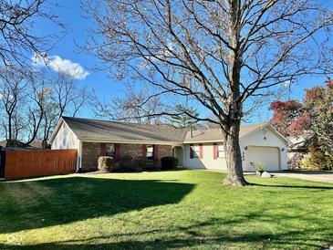 Charming one story home with brick and siding, manicured lawn and mature shade tree at 562 Nelson Dr, Brownsburg, IN 46112
