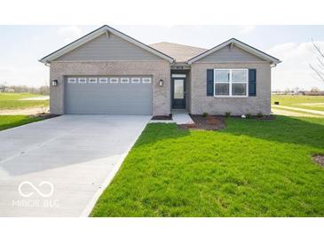 Charming single-story home with a grey brick facade, attached two-car garage, and beautifully manicured lawn at 120 Velvet Hat Rd, Danville, IN 46122