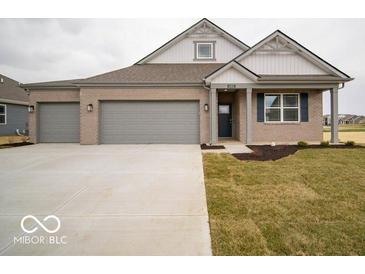 Charming single-story home featuring a three-car garage, a covered porch, and classic brickwork at 6322 Granby Dr, Whitestown, IN 46075
