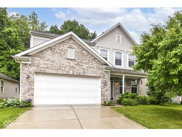 Charming two-story home with a brick facade, attached two-car garage, and well-maintained lawn at 5171 Alpine Violet Way, Indianapolis, IN 46254