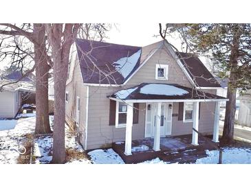 Tan house with front porch, in need of some repairs at 573 W Taylor St, Shelbyville, IN 46176