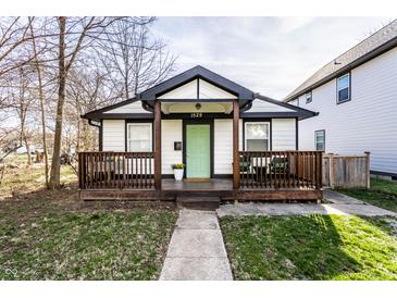 Charming home with a welcoming front porch and light green front door at 1529 Harlan St, Indianapolis, IN 46203