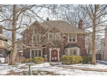 Brick two-story home with mature trees and a manicured lawn at 5815 N Washington Blvd, Indianapolis, IN 46220