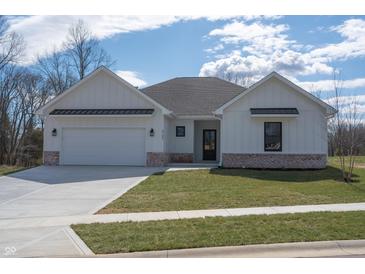 Charming one-story home featuring white board and batten siding, a gray roof, and an attached two-car garage at 5143 Oak Ridge Pl, Columbus, IN 47201