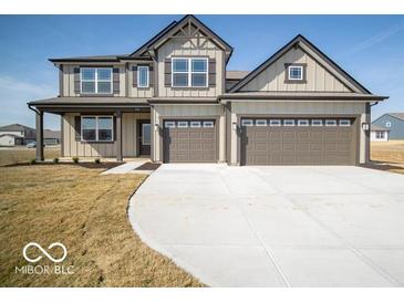 Charming two-story home featuring a neutral color scheme, two-car garage, and well-manicured lawn at 248 Highland Ave, Danville, IN 46122