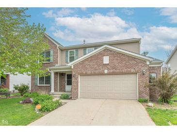 Charming two-story home with a brick facade, attached two-car garage, and well-maintained landscaping at 14446 Chapelwood Ln, Fishers, IN 46037