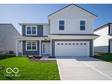 Charming two-story home features a spacious two-car garage and well-manicured lawn at 1573 Hanover St, Danville, IN 46122