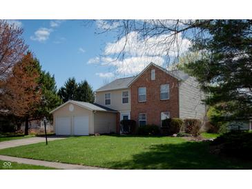 Charming two-story home with a two-car garage, manicured lawn, and a mix of brick and vinyl siding at 9563 England Ct, Noblesville, IN 46060