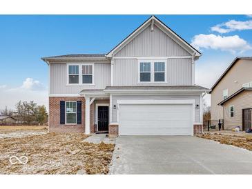 Charming two-story home with a two-car garage, brick accents, and manicured lawn at 1145 Bevy Blvd, Danville, IN 46122