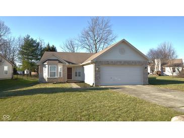 Charming single-story home with a two-car garage and well-maintained lawn on a sunny day at 5250 Shamus Dr, Indianapolis, IN 46235
