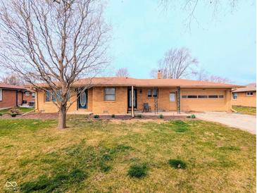 Charming one-story brick home featuring an attached one-car garage and a well-maintained front lawn at 4619 Mac Dr, Anderson, IN 46013