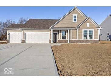 Charming single-Gathering home showcasing a three-car garage and manicured lawn at 310 N Bur Oak Dr, Mooresville, IN 46158