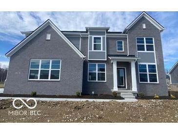 Charming two-story home with gray brick, white trim and a welcoming front porch at 6596 Dogwood Dr, McCordsville, IN 46055