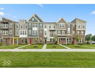 Charming townhomes featuring diverse facades and lush landscaping enhancing curb appeal at 7348 W County Road 600 Rd # 12-604, McCordsville, IN 46055