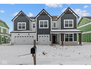 Beautiful new construction home featuring a three car garage, dark trim, and an inviting front porch at 10603 Banyan Wood Ct, Indianapolis, IN 46239