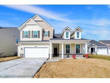Charming two-story home with stone accents, large windows, and a two-car garage at 68 Sterling Pl, New Whiteland, IN 46184