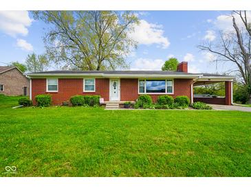 Charming red brick ranch-style home with a well-manicured lawn and attached carport at 56 Hadley Woodland St, Mooresville, IN 46158