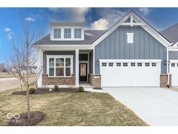 Charming blue two-story home featuring a brick foundation, white trim, and an attached two car garage at 3922 Holly Brook Dr, Westfield, IN 46062